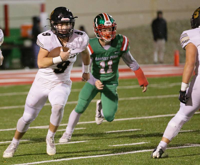 Sycamore's Dawson Alexander (9) runs down the field past L-P's Billy Mini (9) on Friday, Oct. 14, 2022 at Howard Fellows Stadium in Peru.