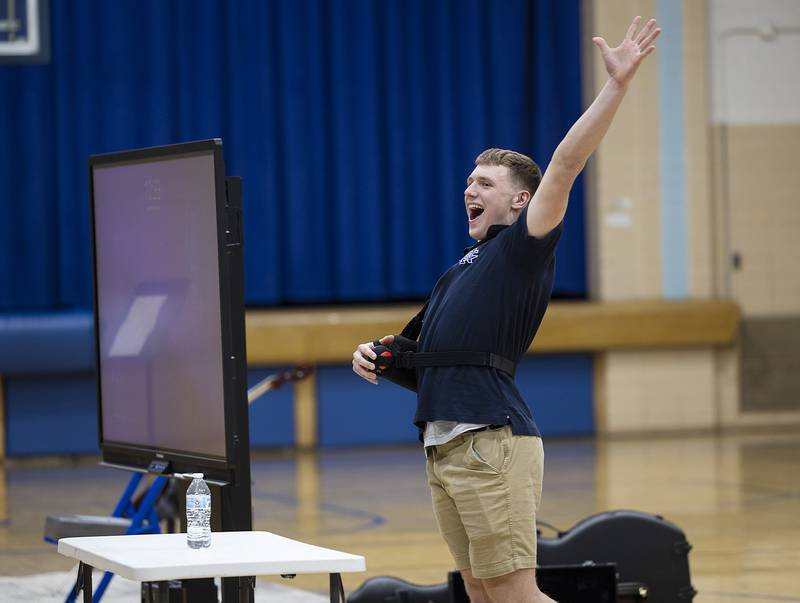 Matt Blackert celebrates a one try bottle flip trick Thursday, Jan. 30, 2025, at Newman High School. NHS held a talent show in celebration of Catholic Schools Week.
