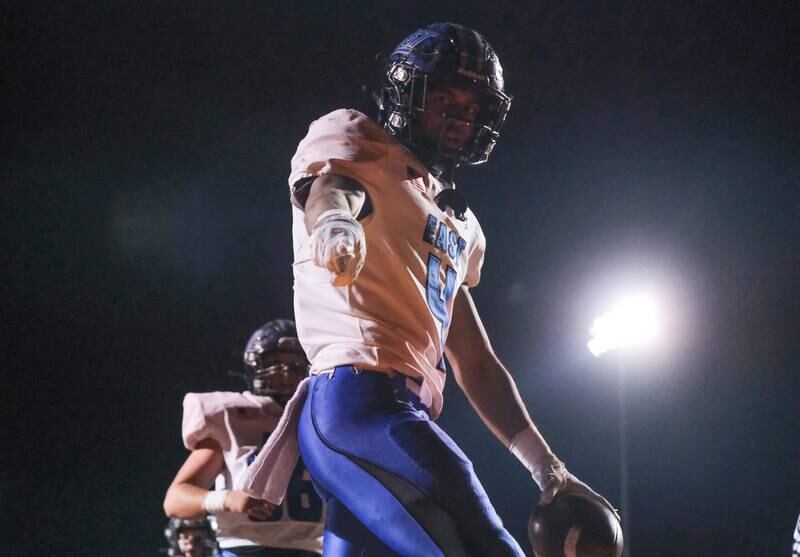 Lincoln-Way East's Trey Johnson points to the camera after scoring against Minooka in the Class 8A 2nd round playoffs in Minooka on Saturday, Nov. 6, 2021.