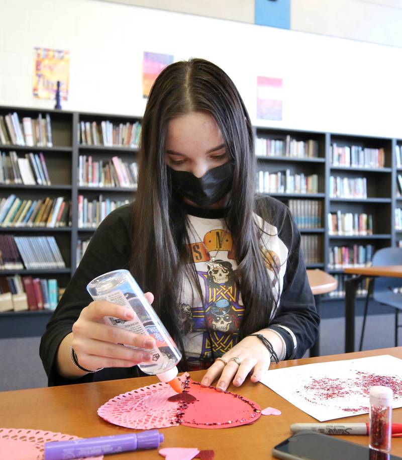 Genoa-Kingston High School freshman Mirela Music makes a Valentines Day card Tuesday, Jan. 25, 2022, in the library at the school. The cards students are making will be part of “Valentines for Seniors,” a card drive for local seniors living in residential care facilities, sponsored by State Representative Jeff Keicher, R-Sycamore, and State Senator Dave Syverson R-Rockford.