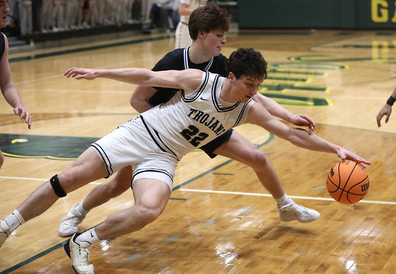 Cary-Grove's Adam Bauer battles with Marmion's Colin McEniry for a loose ball during an IHSA Class 3A Crystal Lake South Regional boys basketball semifinal game on Wednesday, February, 25, 2026, at Crystal Lake South High School.