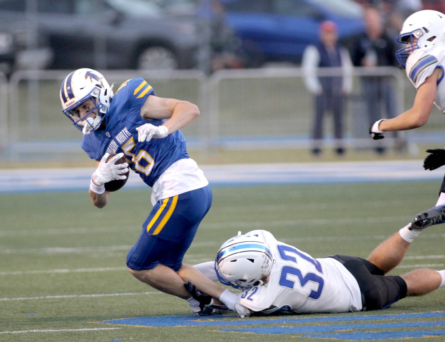 Wheaton North’s Matt Kuczaj (left) is taken down by St. Charles North’s Riley Sprindis during a game in Wheaton on Friday, Sept. 8, 2023.