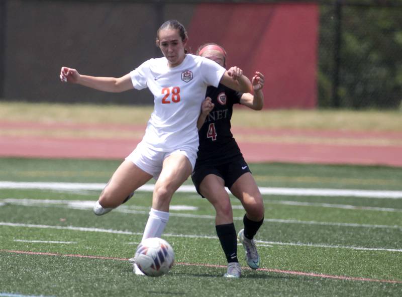 Crystal Lake Central’s Jillian Mueller (left) kicks the ball away from Benet’s Chloe Sentman during a Class 2A girls state soccer semifinal at North Central College in Naperville on Friday, June 2, 2023.