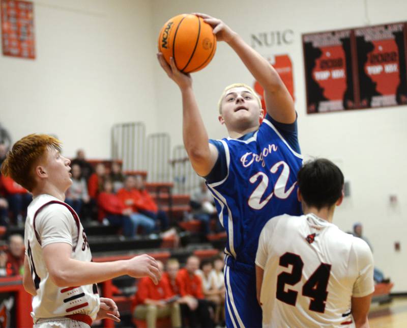 Oregon's Kade Girton (22) drives to the basket as Forreston's Brendan Greenfield (00) draws the charge during a Saturday, Jan. 25, 2025 game at Forreston High School.