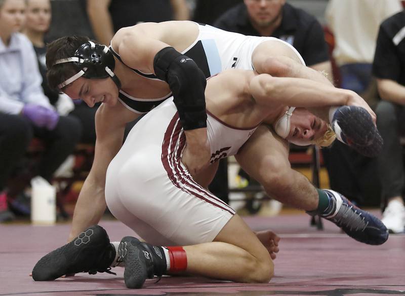 Marian Central’s Nic Astacio battles with Wheaton Academy’s Tyler Jones  in the 165-pound championship match of the IHSA 1A Marengo Wrestling Regional on Saturday, Feb. 8, 2025, at Marengo High School.