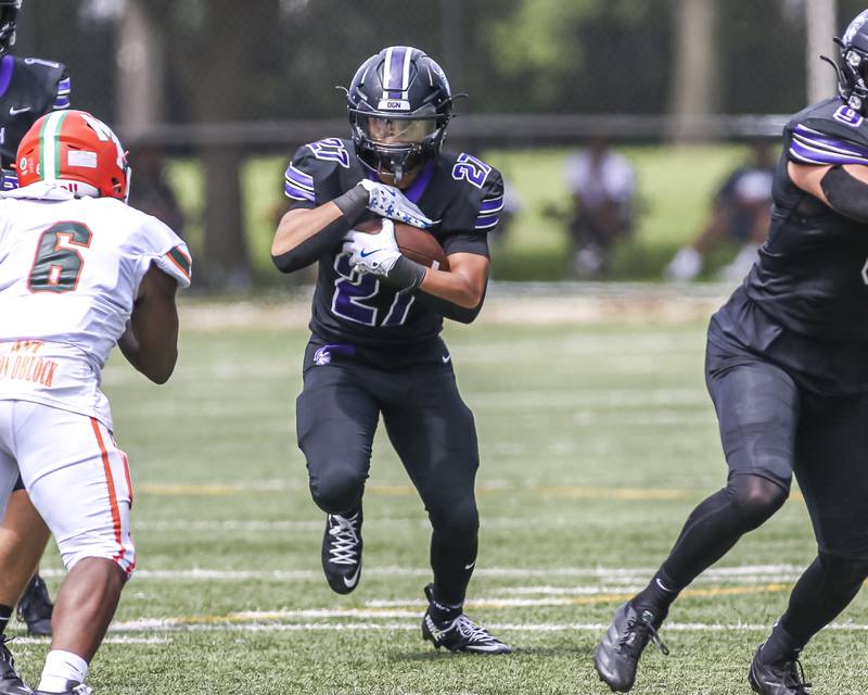 Downers Grove North's Kevin Jay Jr. (27) runs up the middle during football game between Downers Grove North at Morgan Park Saturday, Aug 30, 2025  in Chicago.