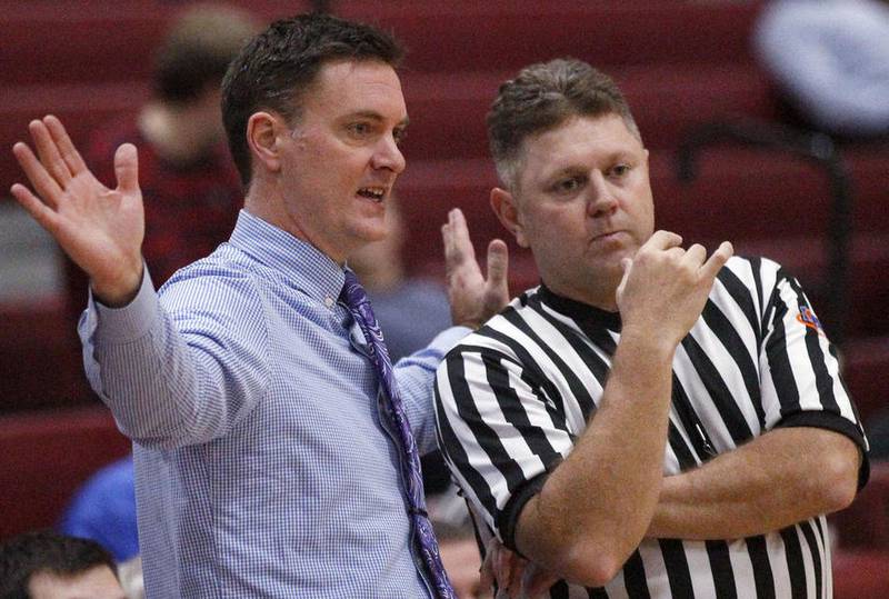 Woodstock coach Al Baker talks about the game with a referee during their semifinal matchup against Rockford Christian in the E.C. Nichols Holiday Classic Basketball Tournament on Tuesday, Dec. 22, 2015 at Marengo Community High School in Marengo.