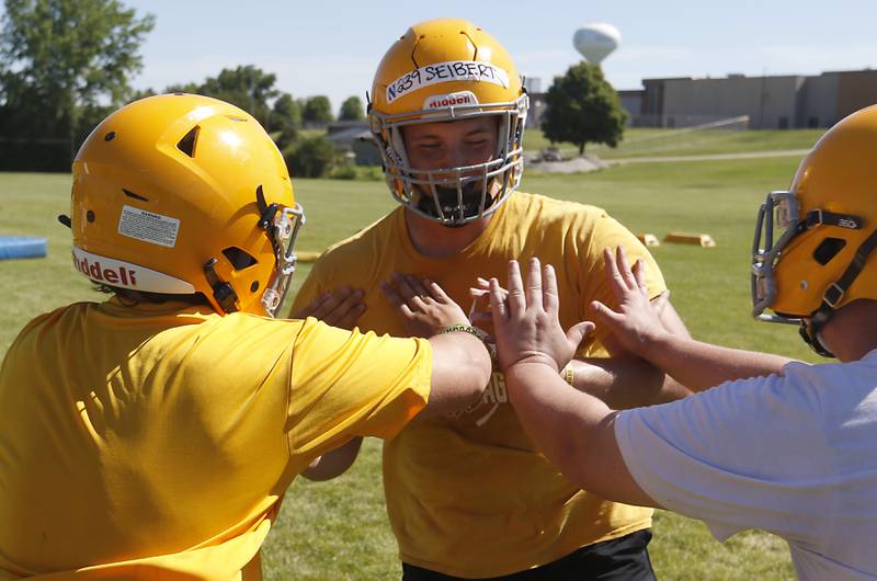 Will Siebert rushes blockers during football practice Monday, June 20, 2022, at Jacobs High School in Algonquin.