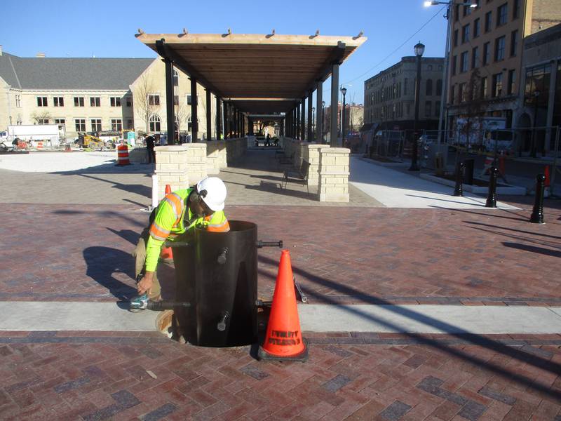Tim Nimon, an electrician for the city of Joliet, prepares the holder in the City Square for the arrival of the annual Christmas tree on Friday. Nov. 14, 2025