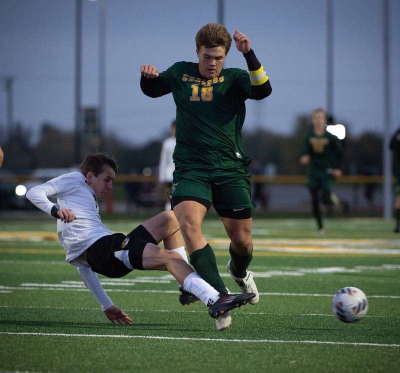 Coal City's Julian Micetich moves the ball down field as Herscher's Owen Bollino punches it away with a tackle during a sectional game on Tuesday, October 28, 2025.