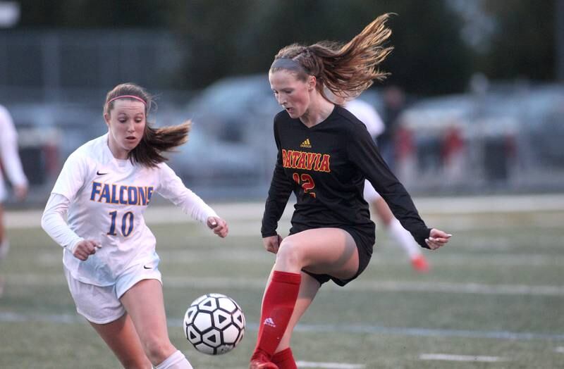 Batavia’s Johanna Shubert (12) gets control of the ball away from Wheaton North’s Addison Falco during a game at Batavia on Thursday, April 7, 2022.