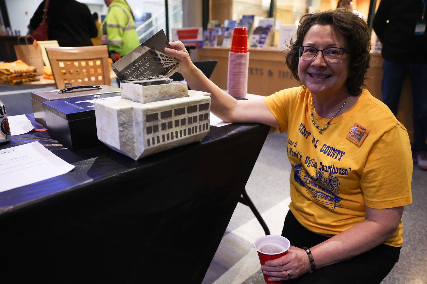 Mary Lynn Maloney poses with her sculpture of the old Will County Courthouse at a kegger fundraiser to save the old courthouse at the Joliet Area Historical Museum on Friday, February 3rd.