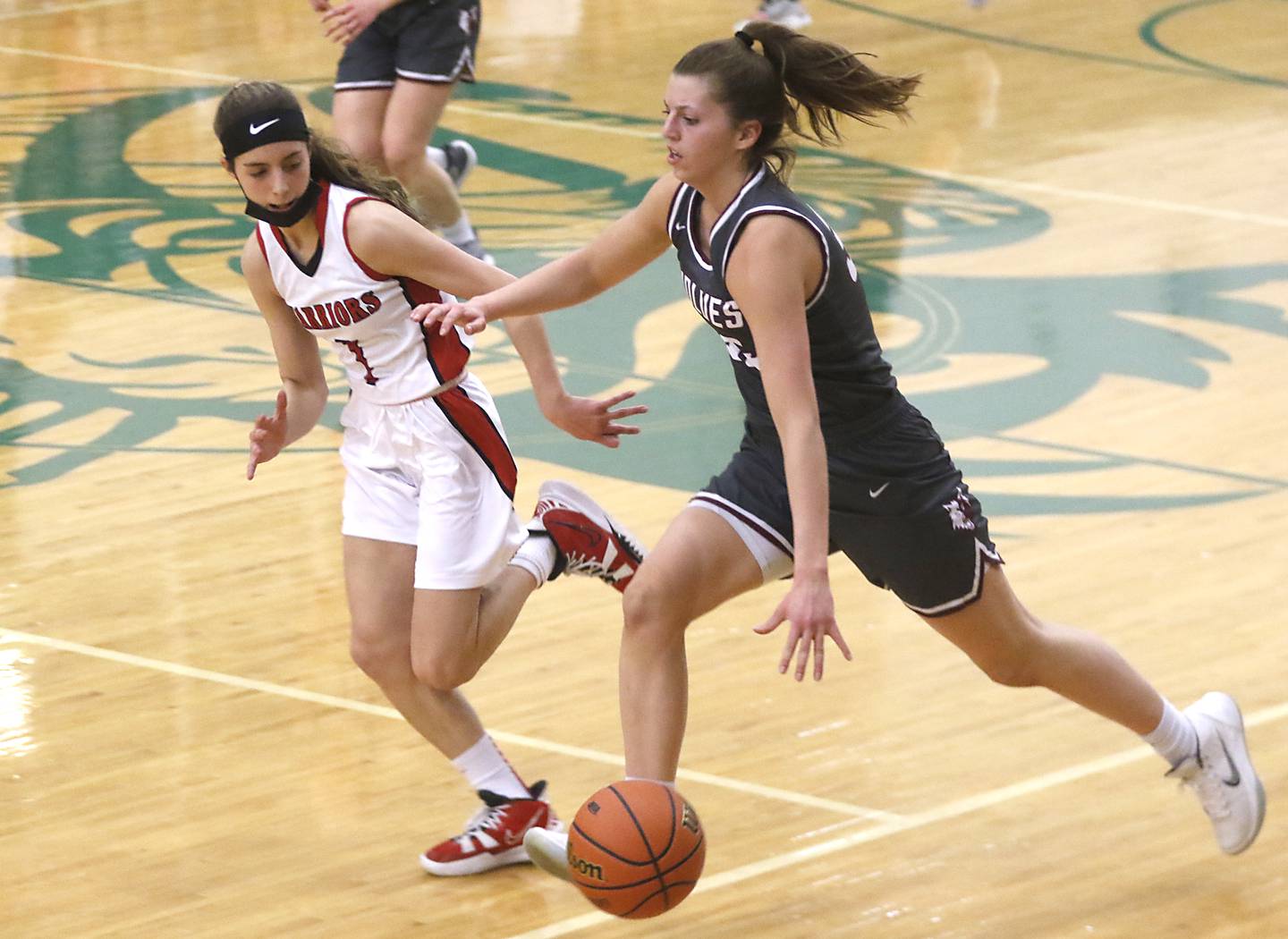Prairie Ridge's Karsen Karlblom pushes the ball up the court against the defense of Deerfield's Nikki Kerstein during a IHSA Class 3A Grayslake Central Sectional semifinal basketball game Tuesday evening, Feb. 22, 2022, between Prairie Ridge and Deerfield at Grayslake Central High School.