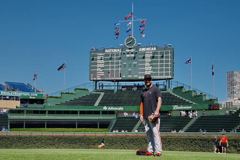 Giants pitcher Jakob Junis poses in front go the iconic Wrigley Field scoreboard on Friday, Sept. 9, 2022. The Rock Falls native,  who grew up a Cubs fan, was at Wrigley Field for the first time as a player.