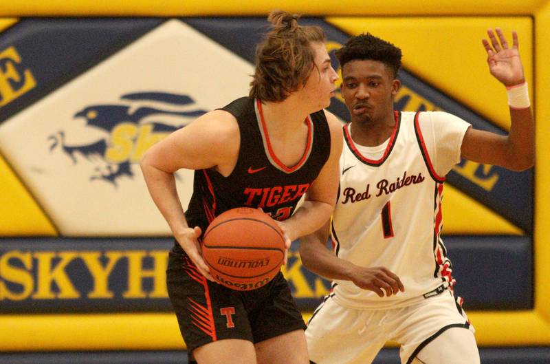 Crystal Lake Central’s Jake Terlecki, left, looks for an option as Huntley’s Bryce Walker defends during tournament basketball action at Johnsburg High School Monday evening.
