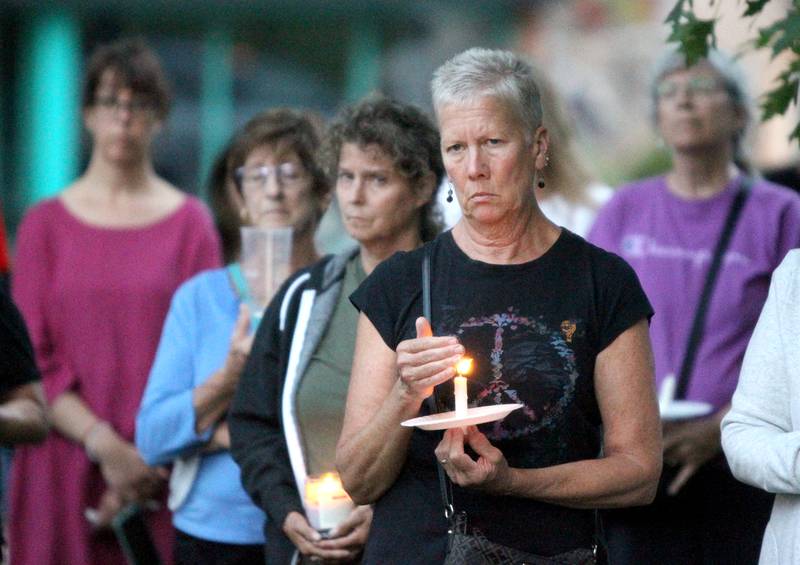 Beth Pappas of Geneva attends a candlelight vigil Wednesday, July 6, 2022, at the Kane County Courthouse in Geneva. The vigil was called to join in solidarity in honor of the mass shooting at a Fourth of July parade in Highland Park.