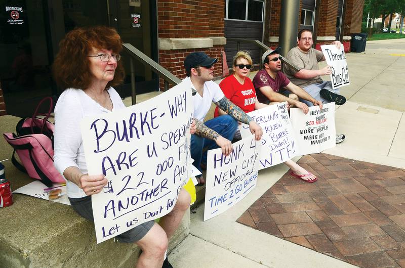 A group of citizens sat outside of Dixon city hall May 11, 2012 to urge mayor Burke to resign amid the Crundwell scandal. Kay Morris (left), Robet Lewis, Jennifer DeMaria, Wes Morss and Jordan Bowman held signs voicing their displeasure.