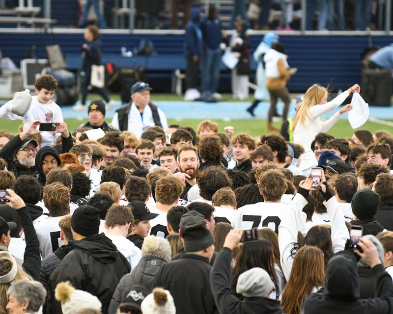 Fenwick's head coach Matt Battaglia, center, talks with the team and fans after beating Nazareth Academy in overtime during the 6A semifinals game on Saturday Nov. 22, 2025, held at Nazareth Academy High School in La Grange Park.