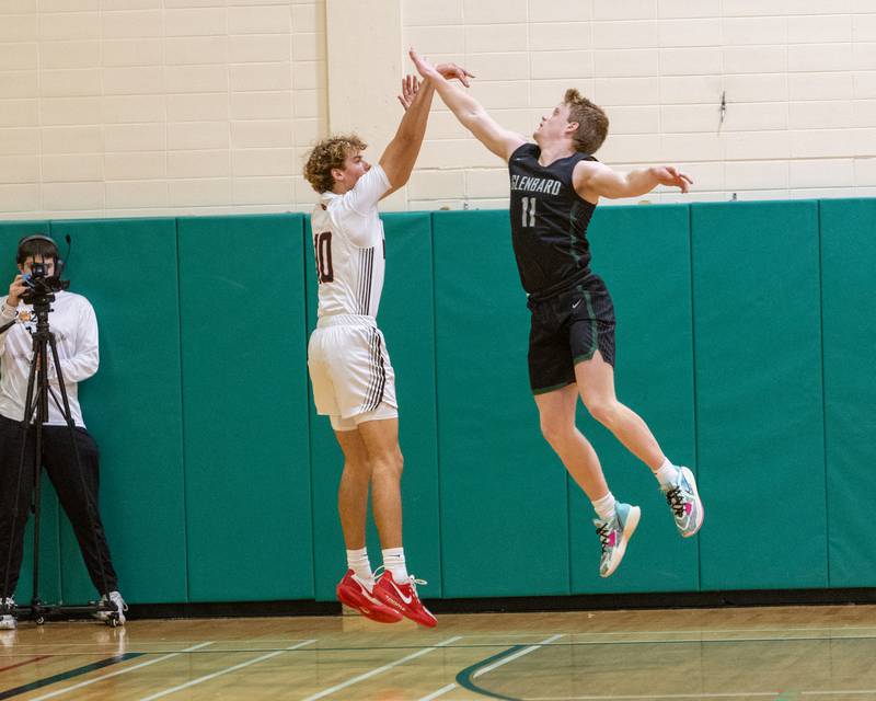Yorkville's Graham Martinson shoots a three pointer over Glenbard West's Chase Cavan on Friday Dec. 26,2025 at the 51st. Annual Jack Tosh Holiday Tournament in Elmhurst.