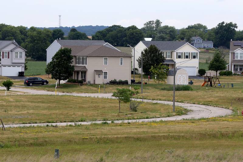 The roads inside the Hebron development on Tamarack Trail are seen with need of much improvement on Wednesday, June 23, 2021 in Hebron.  A lawsuit over who should maintain the roads is in the works after the developer abandoned the half-built community when the recession hit.