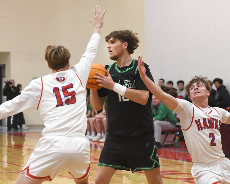 Rock Falls' Cole Munix (12) looks to pass as Oregon's Cooper Johnson (2) and Brian Wallace (15) defend on Friday, Jan. 9, 2026 at the Blackhawk Center in Oregon.