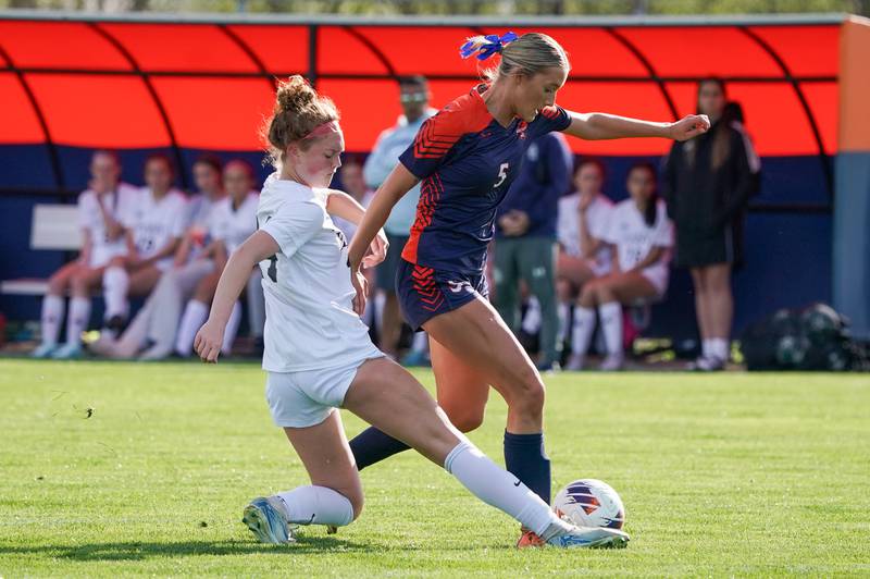Oswego East's Addison Olson, left, challenges Oswego’s Aubrey Eirich (5) for the ball during a soccer match at Oswego High School on Tuesday, April 29, 2025.