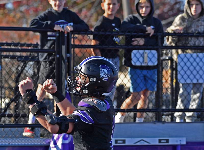 Downers Grove North quarterback Owen Lansu reacts to scoring the first touchdown of the game during a Class 7A quarterfinal against Lincoln-Way West on November 15, 2025 at Downers Grove North High School in Downers Grove .