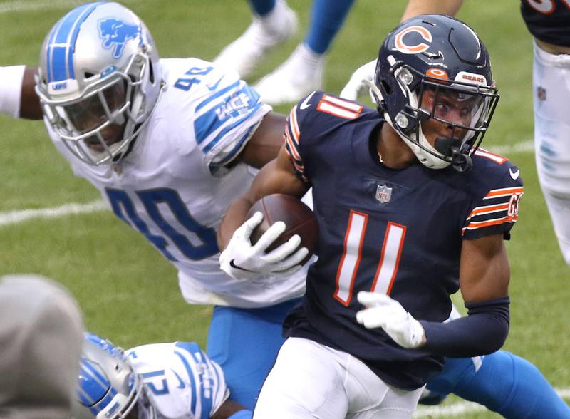 Chicago Bears wide receiver Darnell Mooney gets past Detroit Lions middle linebacker Jarrad Davis during their game Sunday at Soldier Field in Chicago.