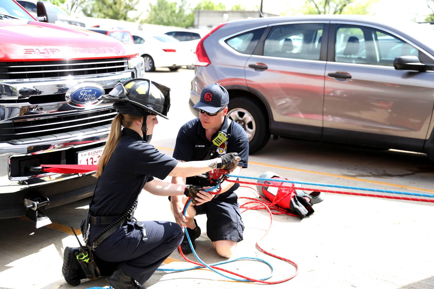 Geneva Fire Department Recruit Kelly Hunecke (left) and Lt. Rob Moore assist in a rappelling training exercise at the Third Street Commuter Parking Deck on Tuesday, May 13, 2025 in Geneva.