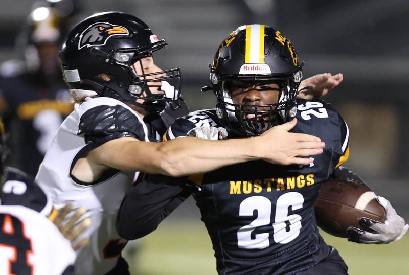 DeKalb's Michael Hodge brings down Metea Valley's Zion Felton on a kickoff return during their game Friday, Sept 15, 2023, at Metea Valley High School in Aurora.