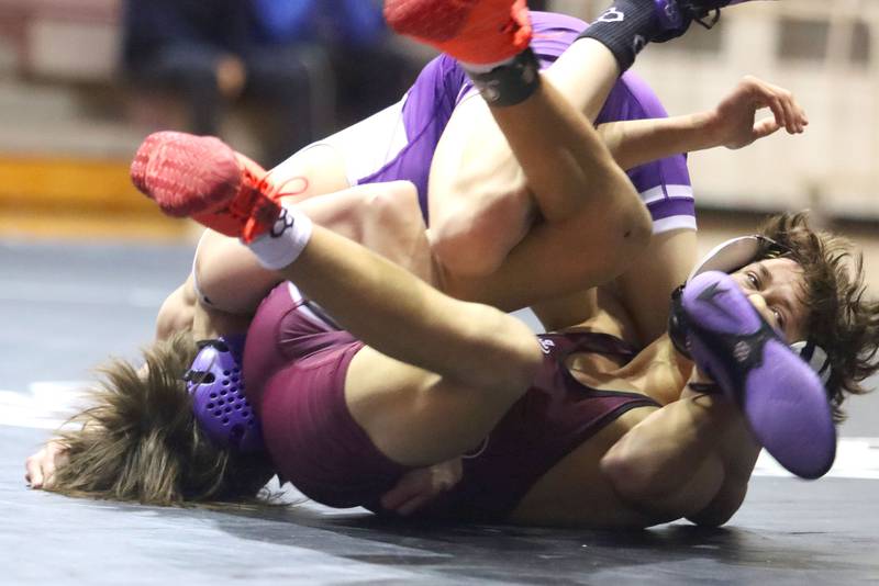 Prairie Ridge’s Tymen Robinson, front, battles Hampshire’s Luthor Rajcewicz at 106 pounds in varsity boys wrestling on Thursday, Dec. 4, 2025, at  Prairie Ridge High School in Crystal Lake.