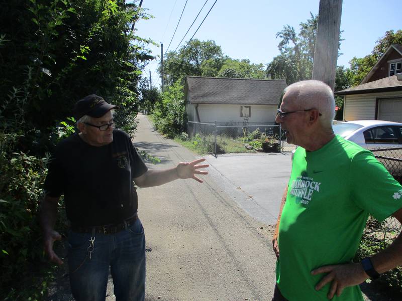 Gene Sorensen (left) and John Sheridan talk on Sept. 15, 2021 about the problems that led to the petition drive to close one end of the alley behind their homes in the Cunningham neighborhood of Joliet.