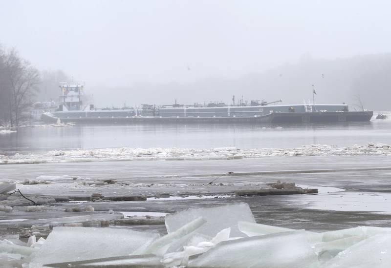A barge navigates icy waters of the Illinois River on Friday, Jan. 26, 2024, in Ottawa.