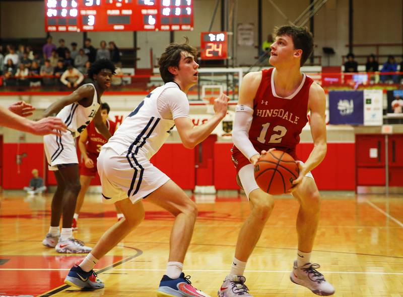 Hinsdale Central's Ben Oosterbaan (12) starts a shot during the Hinsdale Central Holiday Classic championship game between Oswego East and Hinsdale Central high schools on Thursday, Dec. 29, 2022 in Hinsdale, IL.