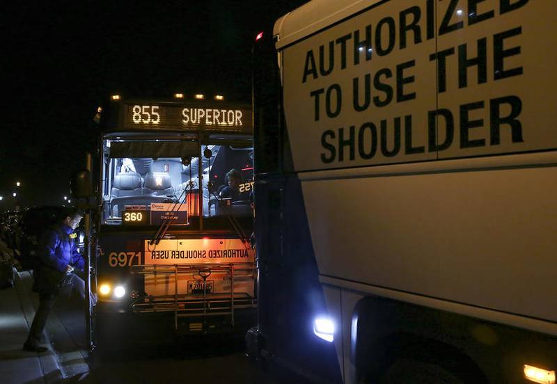 A morning commuter boards the 6971 Pace Express bus outside Plainfield Village Hall in Plainfield in this undated file photo.