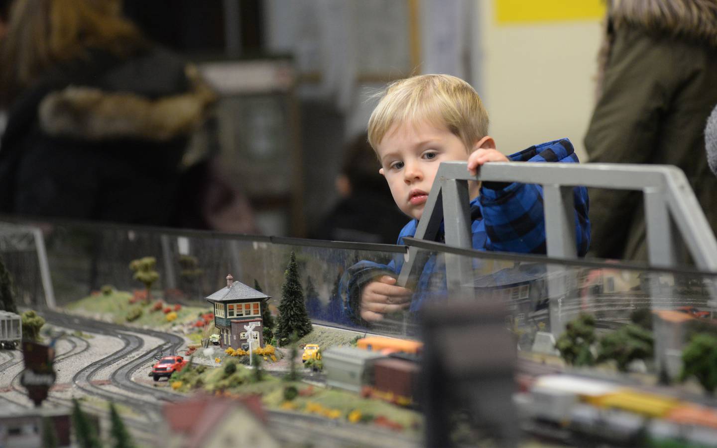 Kieran Russell-Brown, 3, of Oregon, watches a model train at the Blackhawk Model Railroad Club at Conover Square during Oregon's Candlelight Walk on Saturday, Nov. 25. 2023. The evening event also included Christmas music, shopping specials, and visits with Santa.