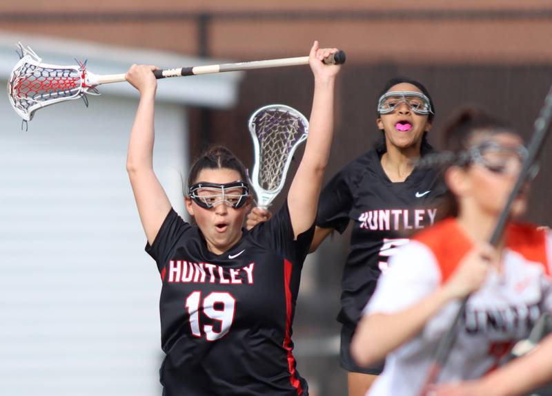 Huntley’s Ally Schneider, left, and Abriy Walker, right, celebrate a Red Raider goal in varsity girls lacrosse on Friday, April 18, 2025, at Metcalf Field on the campus of Crystal Lake Central High School in Crystal Lake.
