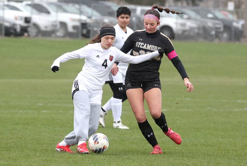 La Salle-Peru's Amelia Buckley tries to hold off Sycamore's Hailey Clawson during their game Wednesday, April 9, 2025, at Sycamore High School.