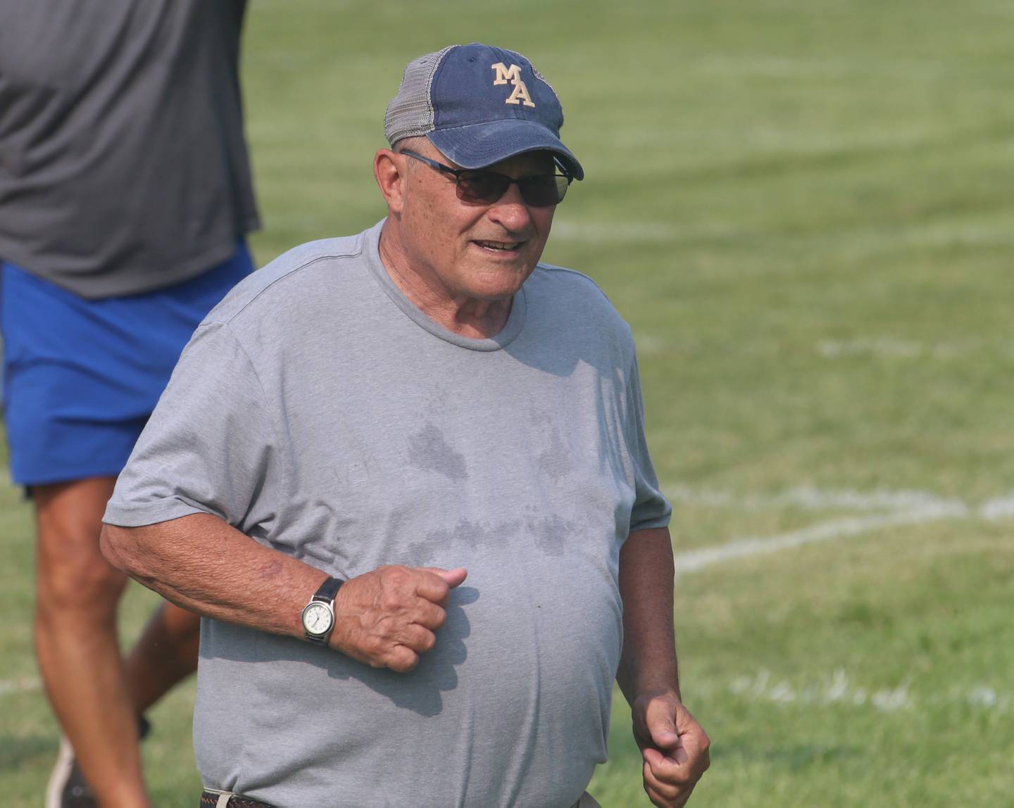 Marquette head football coach Tom Jobst runs with his football team during football camp on Monday, July 24, 2023 on the practice field next to Gould Stadium in Ottawa.
