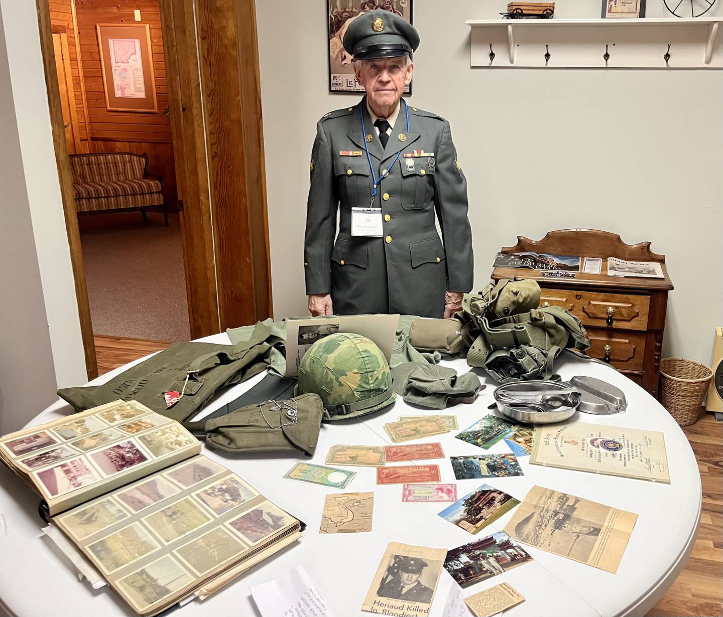 Wendell Dominy, who served in the Army during the Vietnam War from 1965-1966, displays photos and articles detailing his experiences enduring mortar fire in Cam Ranh Bay, north of Saigon.