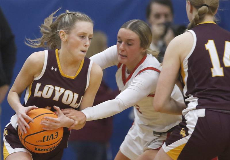 Huntley's Anna Campanelli tries to steal the ball from Loyola Academy's Clare Weasler as she is picked by Loyola Academy's Emily Naraky during the IHSA Class 4A Gurnee Warren Supersectional girls basketball game on Monday, March 3, 2025, at Warren Township High School in Gurnee.