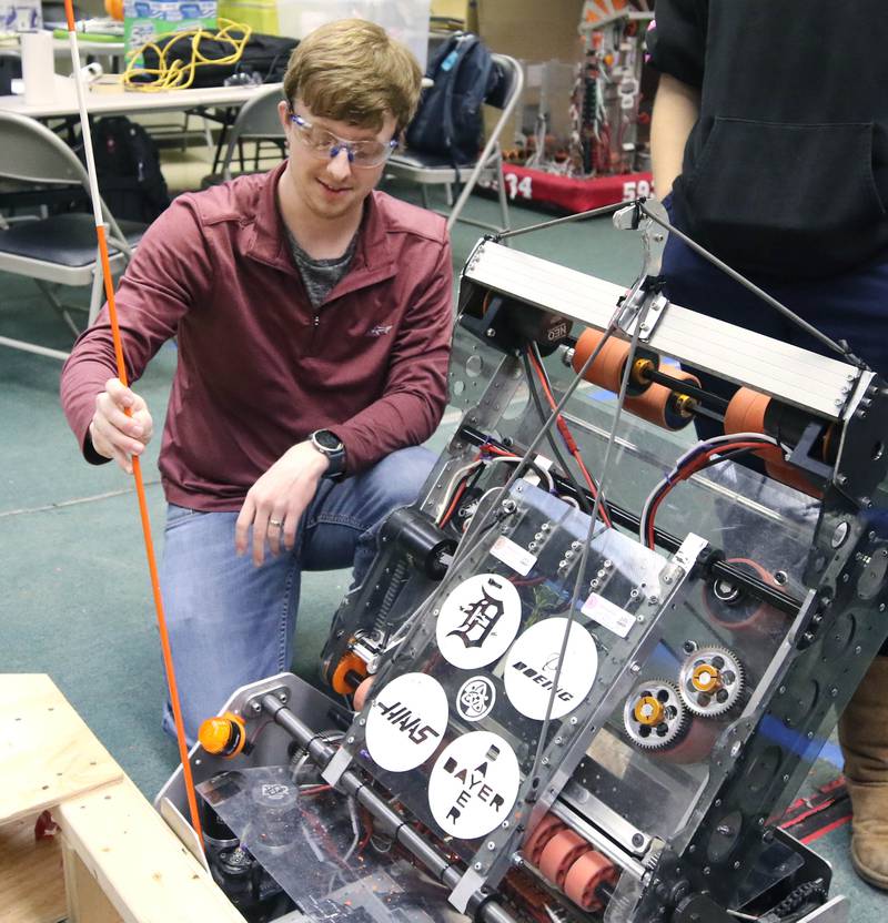 DeKalb High School Crowbotics Team coach Adam VanBoekel checks the teams robot “Pycrowmaniac” Tuesday, April 10, 2024, at Huntley Middle School in DeKalb. Crowbotics is DeKalb High School’s robotics team who has qualified to compete in the FIRST Robotics Competition World Championship held in Houston, Texas April 17-20.