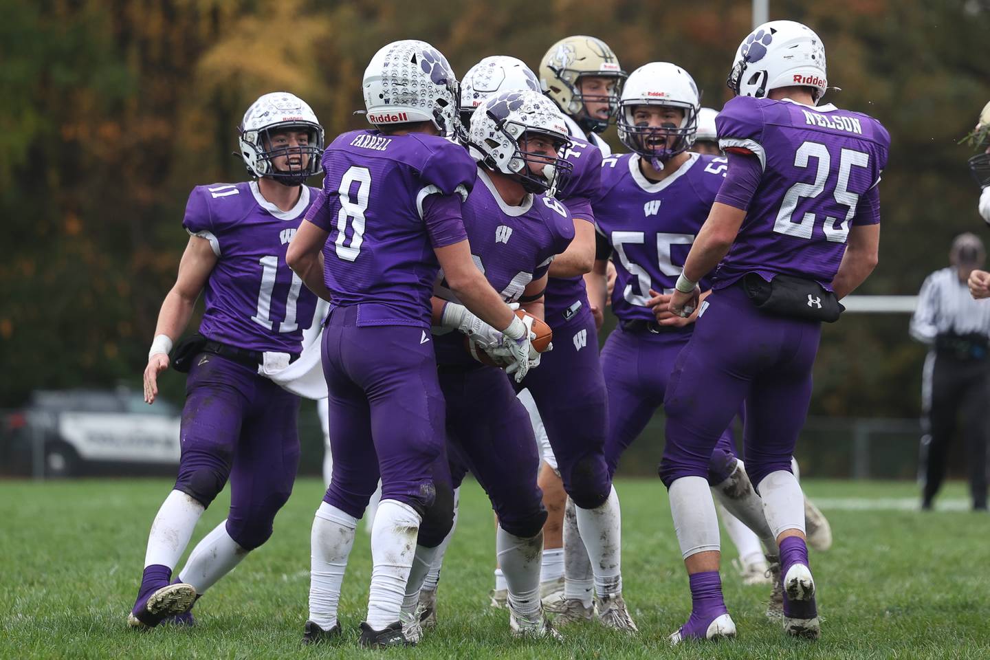 Wilmington’s Joe Allgood in mobbed by teammates after his interception against Mercer County in round 1 of the Class 2A playoffs on Saturday, Oct. 28, 2023 in Wilmington.