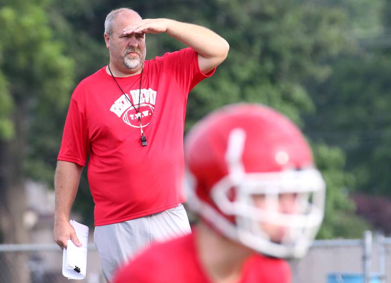 Hall High School football coach Nick Sterling, watches his team run plays during camp on Thursday, July 24, 2025 at Hall High School.