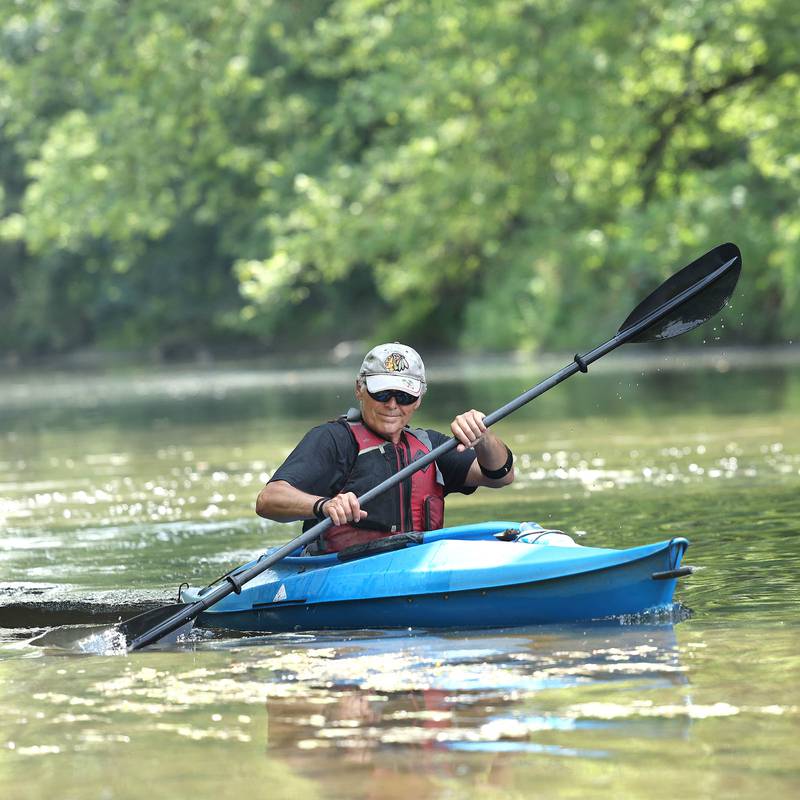 Greg Romaneck picks things up as he kayaks Thursday, Aug. 10, 2023, in the Kishwaukee River near the Knute Olson, Jr. Forest Preserve in Kingston. Romaneck has been making regular visits to pick up trash as he paddles the river and been an advocate for keeping the river and its surroundings free of pollution.