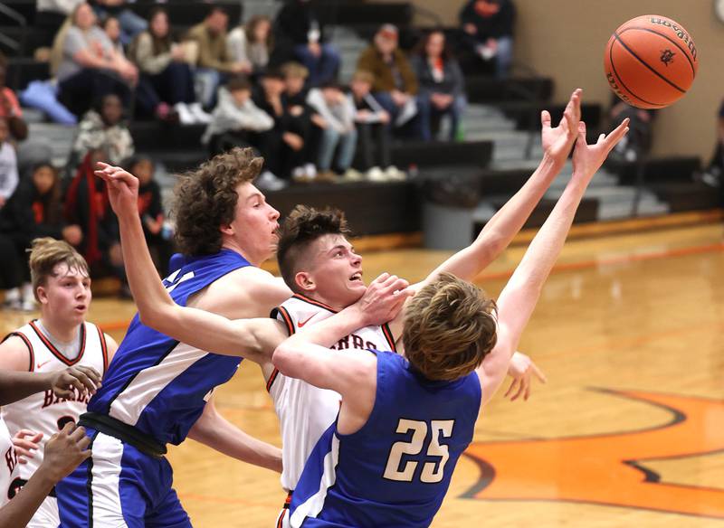 DeKalb’s Jackson Kees goes after a rebound between Geneva’s Andrew Conley (left) and Hudson Kirby Thursday Dec. 28, 2023, during their second round game in the 96th Chuck Dayton Classic boys basketball tournament at DeKalb High School.