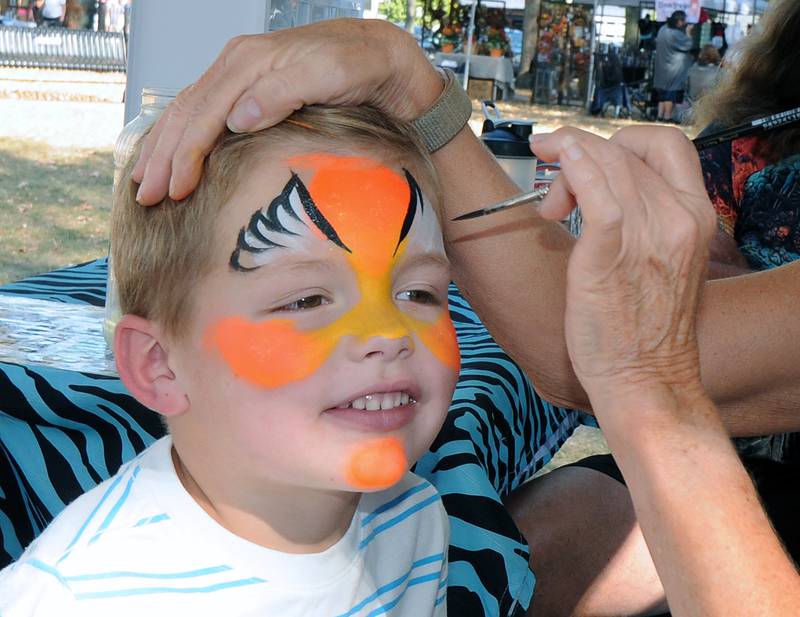 Kanen Taylor is all smiles as he has his face painted Saturday during the annual Scarecrow Festival in Ottawa.