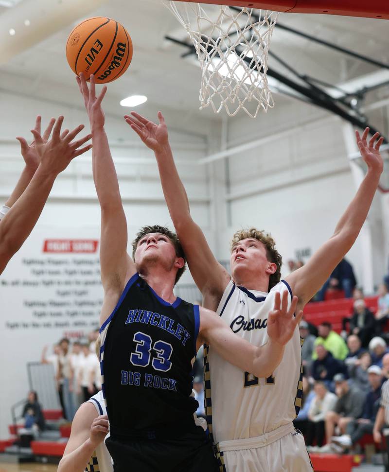 Hinckley-Big Rock's Marshall Ledbetter and Marquette's Lucas Craig go after a rebound Tuesday, March 3, 2026, during their sectional semifinal matchup at Amboy High School.