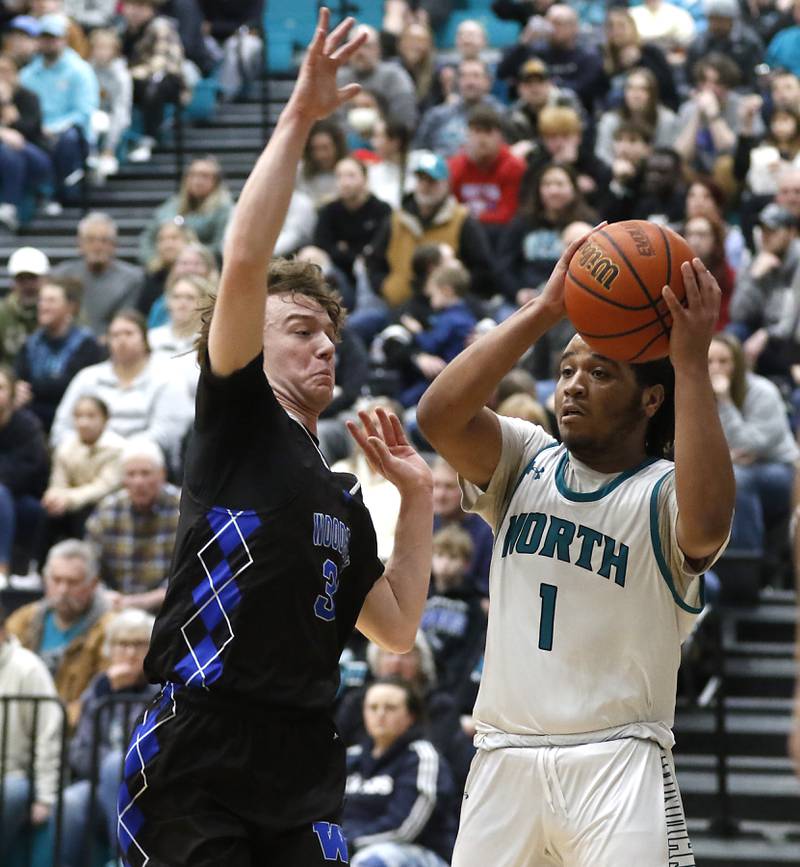 Woodstock North's Elijah White looks to pass as he is defended by Woodstock's Charles Gilmore during a Kishwaukee River Conference boys basketball game on  Friday, Jan. 5. 2024, at Woodstock North High School.