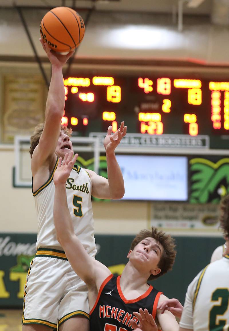 Crystal Lake South's Carson Trivellini shoots the ball over McHenry's Blake Renfro during a Fox Valley Conference boys basketball game on Wednesday, Jan. 14, 2026, at Crystal Lake South High School.